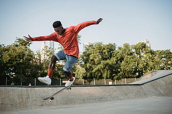 skateboarding, skateboard trick, young man, outdoor skate park, sunny day, skateboarding action, skateboarder, skate park, skateboarding skills, outdoor activity, skateboard jump