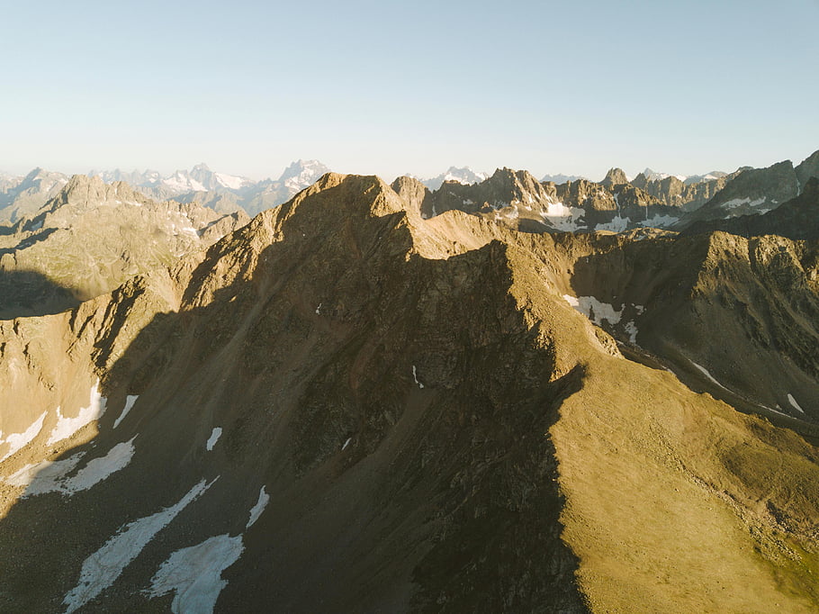 Caucasus Mountains, Karachay-Cherkessia, Russia, drone shot, daylight, bird's eye view, rocky mountains, dramatic landscape, mountain peaks, aerial photography, natural scenery