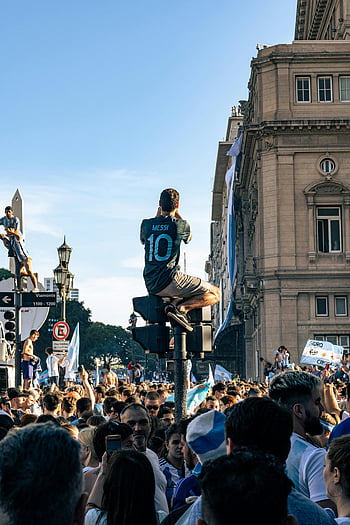 Messi jersey, FIFA World Cup 2022, Buenos Aires, Argentina, crowd celebrating, street celebration, Argentina fans, Messi fan, World Cup victory, Argentina victory, Messi 10