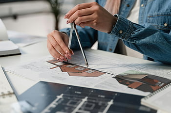 compass, blueprints, office desk, creative professional, architectural design, drafting tools, blueprint review, construction planning, design process, precision measurement, workspace tools