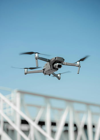 drone camera, flying drone, clear blue sky, modern technology, sleek drone, in flight, drone photography, aerial view, drone technology, blue sky background, drone flight