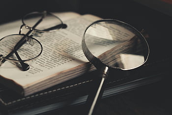 gray magnifying glass, eyeglasses, open book, close-up, discovery, exploration, detailed, vintage, reading, study, knowledge