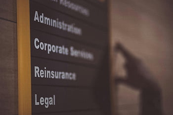 office directory, administration, corporate services, reinsurance, legal, labeled board, close-up, department sign, office sign, business signage, professional office