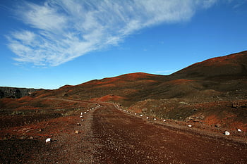 brown road, barren red hills, white clouds, blue sky, daytime, scenic dirt road, clear blue sky, winding road, natural landscape, outdoor scenery, desert landscape