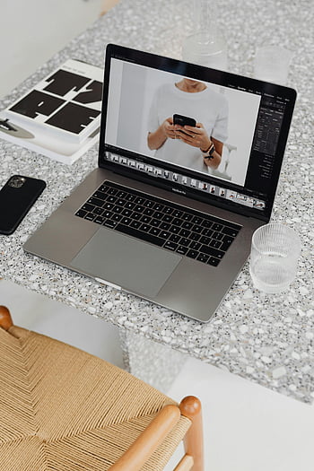 laptop, terrazzo table, smartphone photo edit, stylish workspace, MacBook Pro, photo editing software, modern desk setup, workspace aesthetics, digital workspace, photo editing process, smartphone photography