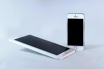 Silver iPhone 5s, White Samsung Android Smartphone, smartphone comparison, mobile devices, technology, Apple iPhone, Samsung phone, white background, tech gadgets, electronic devices, cell phones