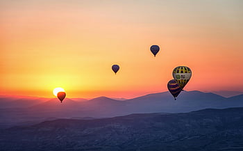 hot air balloons, sunset, mountainous landscape, stunning view, floating balloons, sunrise, assorted balloons, aerial view, colorful balloons, scenic view, nature photography