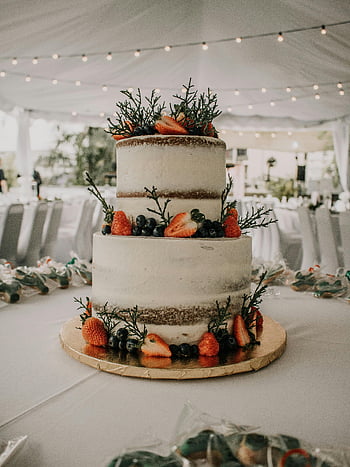 naked cake, two-tier cake, fresh strawberries, blueberries, decorated reception tent, wedding cake, fruit cake, rustic cake, outdoor wedding, cake decoration, tent reception