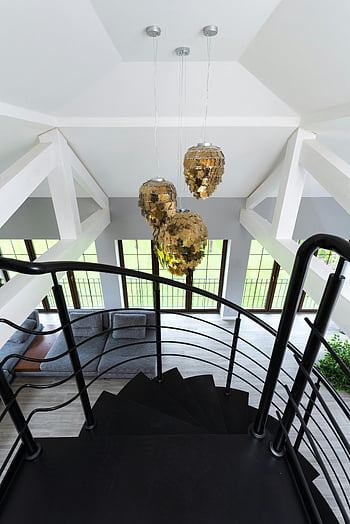 modern loft, spiral staircase, unique pendant lights, golden shimmering lamps, spacious interior, contemporary design, high ceiling, interior design, luxury home, architectural features, hanging lights