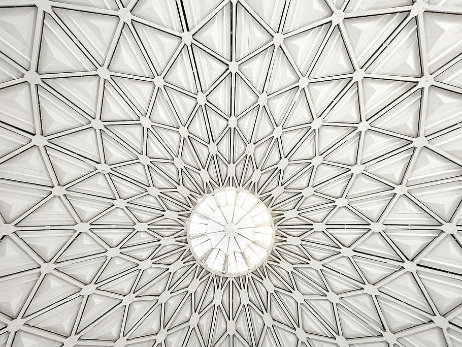 geometric dome ceiling, intersecting patterns, central light source, aesthetic design, bright pattern, architectural ceiling, modern ceiling, geometric patterns, dome structure, interior design, light fixture