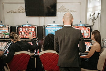 slot machines, casino, adults playing, stylish casino, group of adults, gambling, gaming, entertainment, leisure, indoor setting, slot machine players