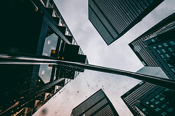 concrete buildings, futuristic skyscrapers, modern cityscape, low angle view, dynamic perspective, urban architecture, city skyline, contemporary design, architectural photography, urban landscape, reflective surfaces