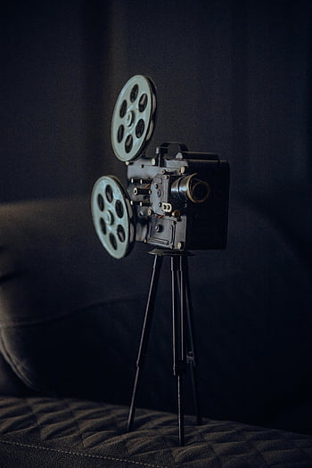 antique film projector, tripod stand, classic cinematic era, vintage camera, close-up, film reels, old projector, retro cinema, antique projector, classic projector, vintage film equipment