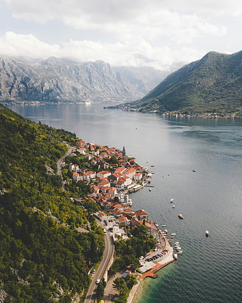 Perast, Bay of Kotor, Montenegro, aerial view, charming town, picturesque bay, surrounded by mountains, coastal town, scenic landscape, waterfront village, mountainous backdrop