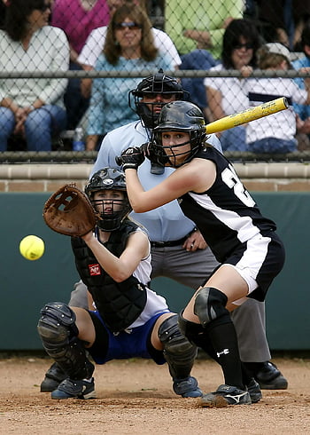 female softball players, softball game, catcher in action, batter swinging, female athletes, softball stadium, sports action, softball equipment, game energy, sports photography, softball competition