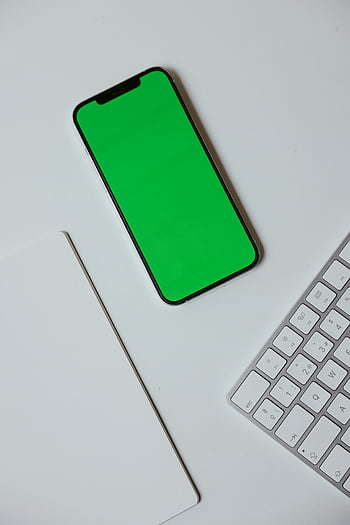 smartphone, green screen, overhead view, keyboard, white desk, technology, mobile device, digital, workspace, modern, gadget