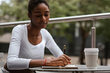 Black woman, coffee, pen, terrace, African American, writing, notebook, cafe, outdoors, table, writing-in-notebook