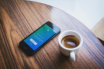 White Ceramic Teacup, Black Iphone 5, Brown Wooden Table, smartphone, Twitter app, cup of coffee, close-up, wooden table, coffee cup, smartphone app, Twitter login