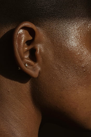ear piercing, black woman, close-up shot, natural skin texture, detailed photo, ear detail, skin close-up, ear jewelry, ear close-up, black skin, ear texture