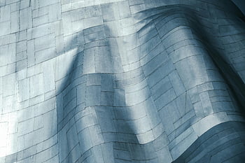 metallic surface, modern architecture, wavy design, close-up view, architectural design, textured surface, contemporary design, abstract pattern, metallic texture, modern building, architectural detail