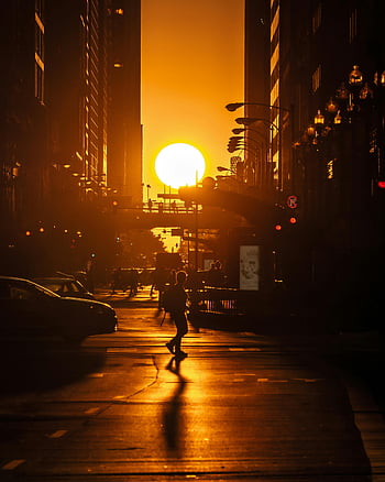 sunset silhouette, person walking, Chicago street, vibrant sunset, dramatic silhouette, urban sunset, cityscape photography, street photography, golden hour, city sunset, urban scene