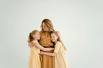 mother, daughters, hugging, family love, togetherness, soft background, light background, embrace, motherhood, family bonding, children