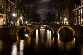 night photography, Brown Concrete Bridge, Amsterdam canal, illuminated bridge, night view, reflecting lights, water reflection, canal lights, urban night scene, cityscape photography, architectural photography