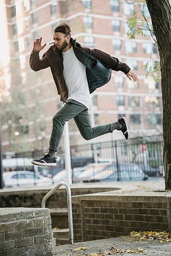 young man, jumping, street, parkour, leap, urban setting, agility, dynamic movement, outdoor activity, cityscape, action shot