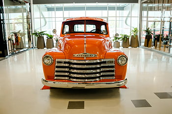 Klasický oranžový chevrolet, Vintage Orange Chevrolet Truck, Moderní showroom, čelní pohled, Historické auto, klasické auto, oranžové auto, kamion chevrolet, ročník vozidla, Showroom Display, klasické vozidlo