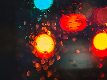 red bokeh, yellow bokeh, blue bokeh, colorful lights, night photography, bokeh effect, vibrant colors, abstract lights, raindrops on glass, night scene, light blur