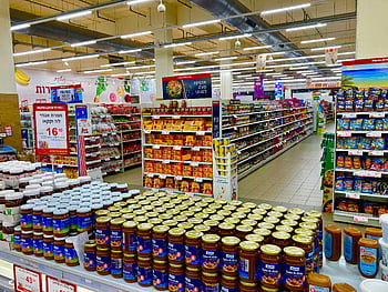supermarket interior, fully stocked shelves, grocery store aisle, product display, canned goods, jarred products, retail environment, supermarket products, wide view aisle, grocery shopping, store shelves