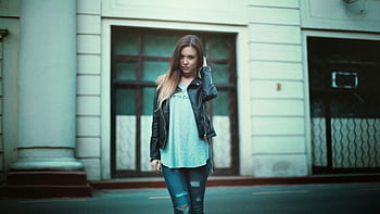 fashionable woman, gray printed shirt, black leather jacket, black distressed jeans, outdoor city pose, urban fashion, stylish outfit, casual look, modern style, street style, woman in leather jacket