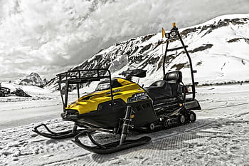yellow snowmobile, black snowmobile, snowy landscape, majestic mountains, winter adventures, snowmobile adventure, pristine snow, mountain backdrop, outdoor recreation, winter sports, snowmobile touring