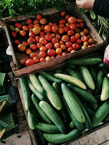 cucumbers, tomatoes, wooden crates, farmers market, vibrant vegetables, fresh produce, local market, healthy food, organic vegetables, market display, fresh cucumbers