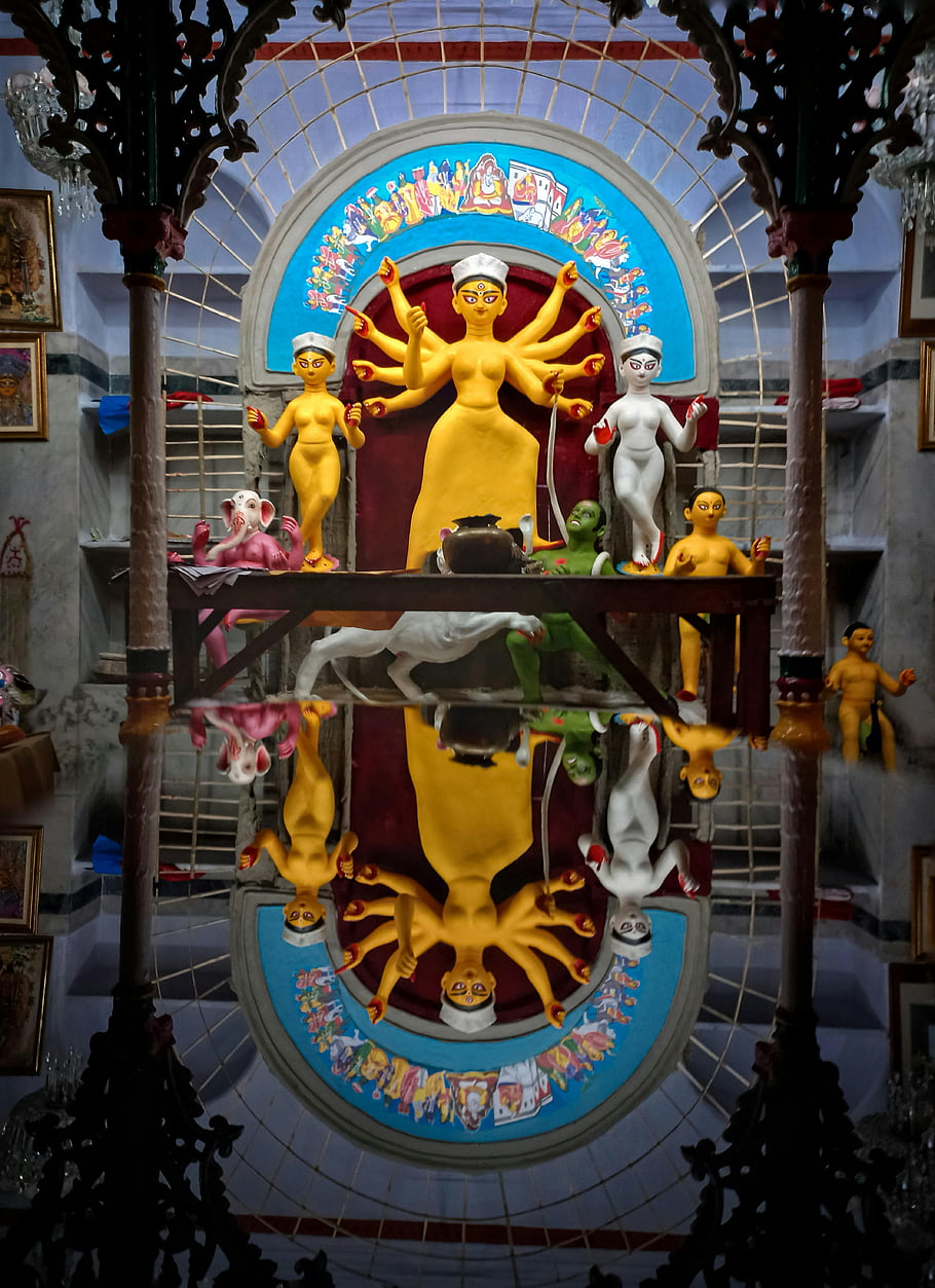 Hindu goddess statues, colorful statues, temple setting, Kolkata, India, reflection, religious art, cultural heritage, temple interior, goddess Durga, Hinduism
