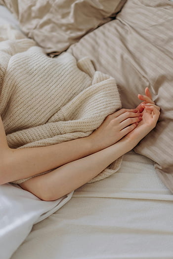 woman in bed, soft bedding, serene bedroom, relaxation themes, cozy bed, comfortable bed, peaceful scene, woman resting, soft textures, calm atmosphere, neutral colors