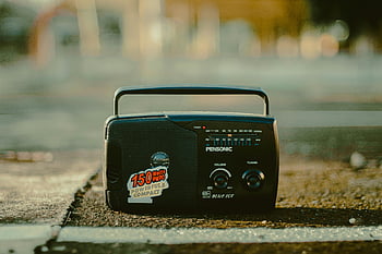 old radio, retro portable radio, vintage radio, nostalgic vibe, urban surface, shallow focus, compact radio, powerful radio, blue ice, 150 watts, portable radio