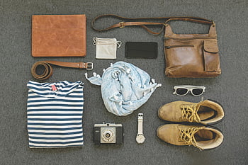 vintage travel essentials, flat lay, leather bags, shoes, camera, clothing, striped shirt, scarf, sunglasses, watch, belt