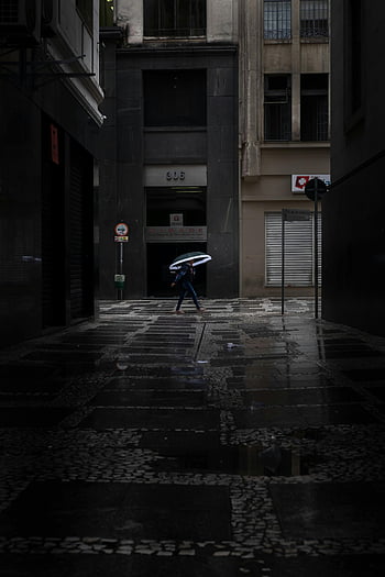 person walking, umbrella, dark alley, rainy alley, urban downtown, wet pavement, city street, rainy day, dark urban scene, person with umbrella, rainy weather