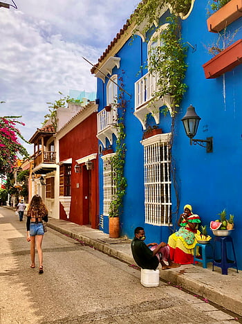 Cartagena, colorful buildings, colonial architecture, vibrant urban life, local vendors, city street, colorful facades, street scene, tourist destination, South America, Caribbean culture