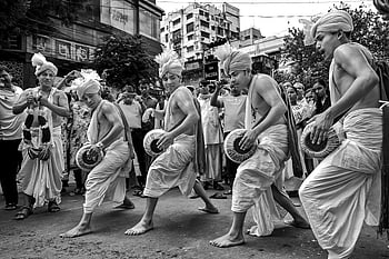 street parade, traditional dancers, festive parade, Kolkata, cultural heritage, street performance, cultural event, traditional attire, public celebration, Indian culture, street festival
