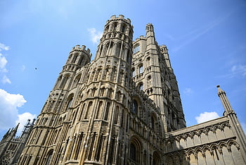 Ely Cathedral, white cathedral, low-angle view, vibrant blue sky, England, architectural details, historic building, medieval architecture, gothic style, church towers, religious landmark