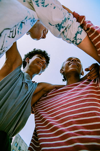 happy young teenage boys, hugging, friendship, fun, blue sky, group of teenagers, enjoying moment, outdoor, smiling, togetherness, joy