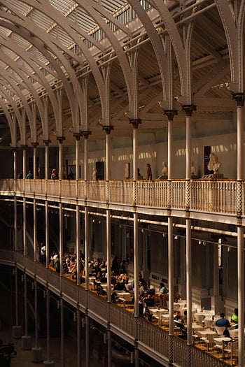 Victorian architecture, people inside museum, vibrant historic setting, museum interior, Victorian building, historic architecture, museum visitors, interior design, cultural heritage, architectural details, museum atmosphere