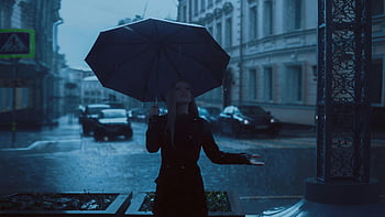 woman holding umbrella, rainy day, moody cityscape, urban scene, wet streets, overcast weather, city life, street photography, atmospheric image, rainy weather, umbrella in rain