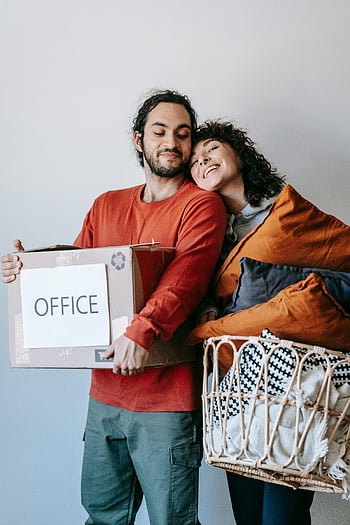 moving couple, man carrying box, woman with throw pillows, joyful couple, holding boxes, holding baskets, moving day, office box, embracing couple, new home, moving in