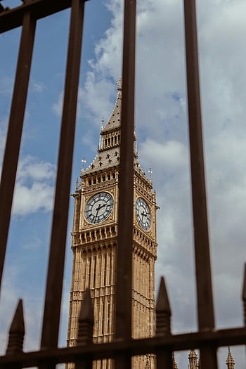 Big Ben, London, clock tower, metal fence, low angle view, historic charm, Elizabeth Tower, United Kingdom, iconic landmark, British architecture, sky view