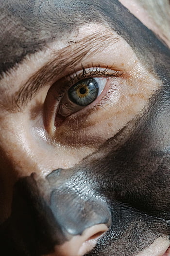 female, clay facial mask, close-up, woman's eye, black clay mask, skincare routine, intimate photo, facial treatment, beauty routine, eye detail, natural skincare