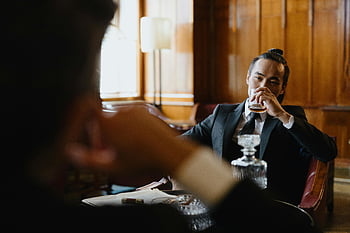 スーツを着た男、 飲酒、 豪華なラウンジ、 洗練された男、 飲み物を楽しんでいます、 テーブル、 エレガントな設定、 フォーマルな服装、 高級な環境、 洗練された雰囲気、 飲み物を飲む紳士