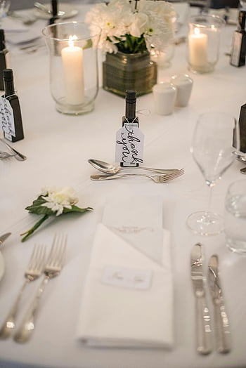 banquet table, white flowers, candles, luxurious table setting, elegant occasion, table decor, wedding table, formal dinner, event table, table arrangement, candlelight dinner